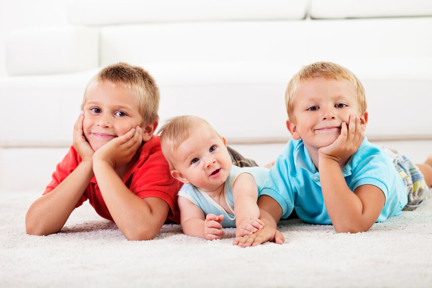 Image of three children lying on carpet after residue-free carpet cleaning in Chesterfield